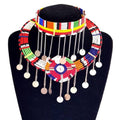 Colorful beaded necklace with hanging elements on a black stand