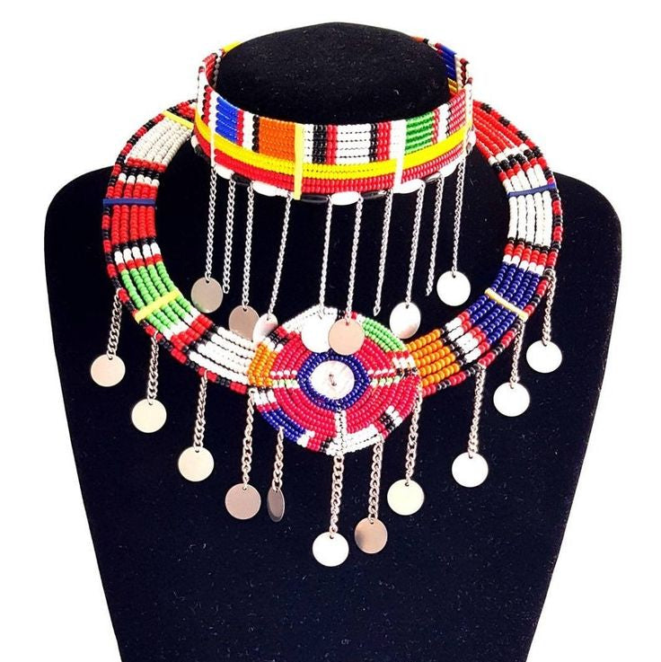 Colorful beaded necklace with hanging elements on a black stand