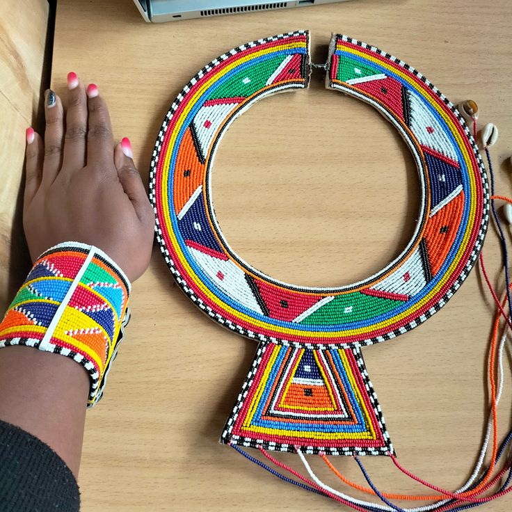Colorful beaded necklace and bracelet on a wooden surface