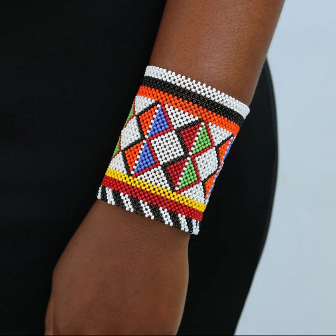 Colorful beaded bracelet on a wrist with a black and white background