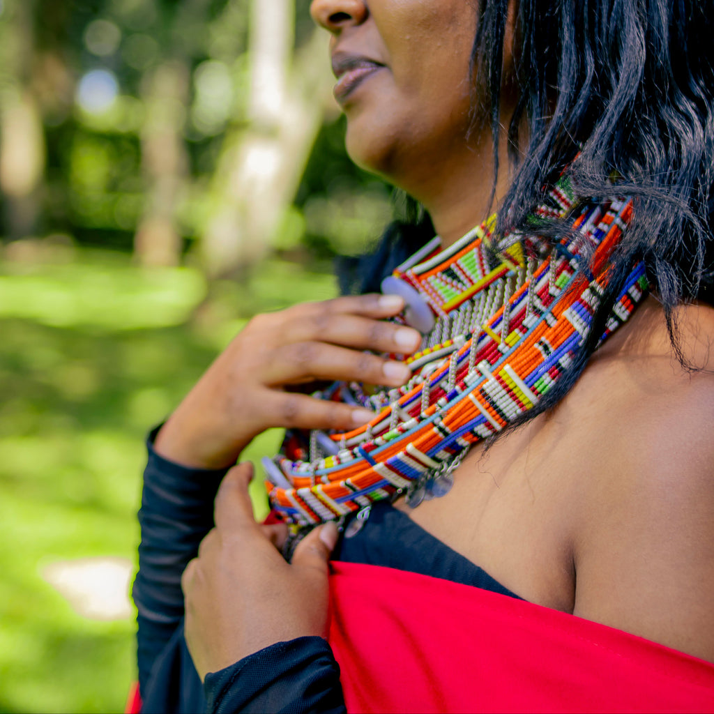 Woman wearing a colorful woven garment in a natural setting