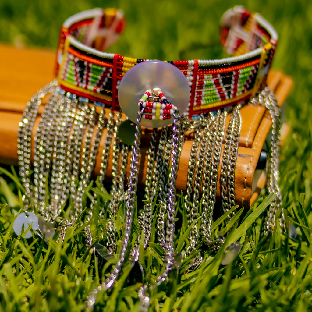 Decorative dog collar with beads and chains on grass