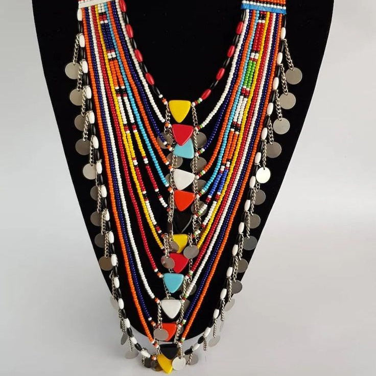Colorful beaded necklace on a black mannequin against a white background
